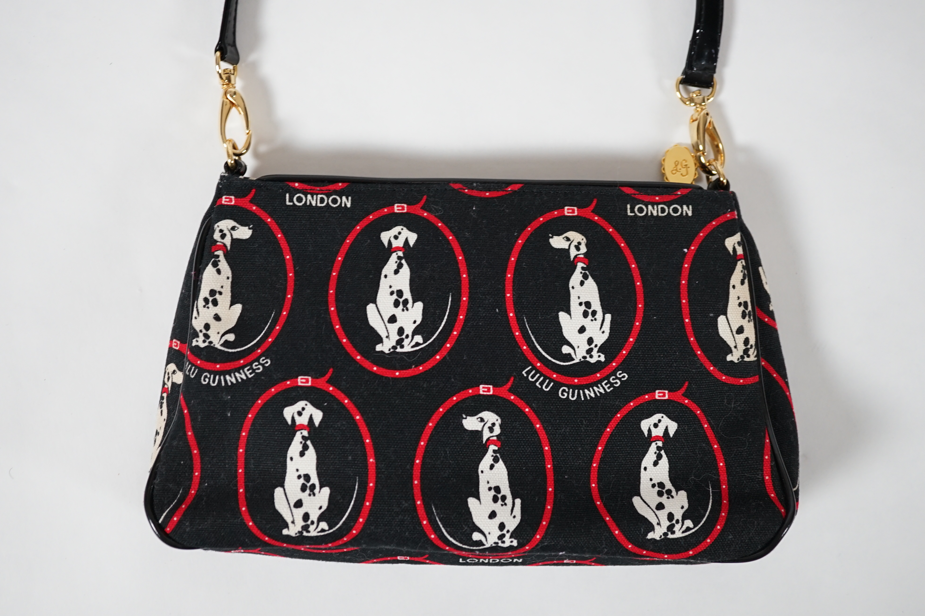 A vintage Lulu Guinness black canvas Dalmatian handbag with black patent leather strap and piping, height 15cm, height to strap 37cm, width 24cm, depth 5cm